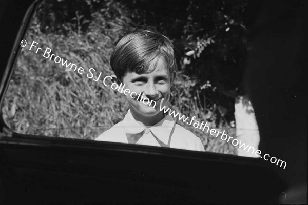 BOY LOOKING IN CAR WINDOW